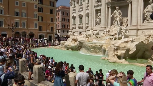 Woman captured on video climbing Rome's Trevi Fountain to fill up water bottle