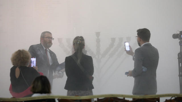 Far-right Polish lawmaker Grzegorz Braun douses menorah in parliament