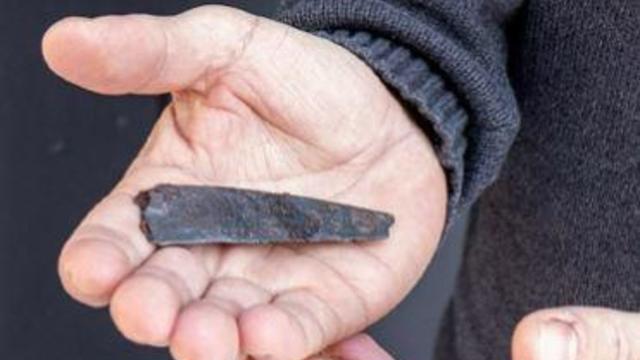 Archaeologists say single word inscribed on iron knife is oldest writing ever found in Denmark