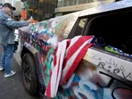 Rowdy Trump supporters dance atop graffitied Tesla Cybertruck outside Trump Tower, say they're done with ‘boomer’ Biden